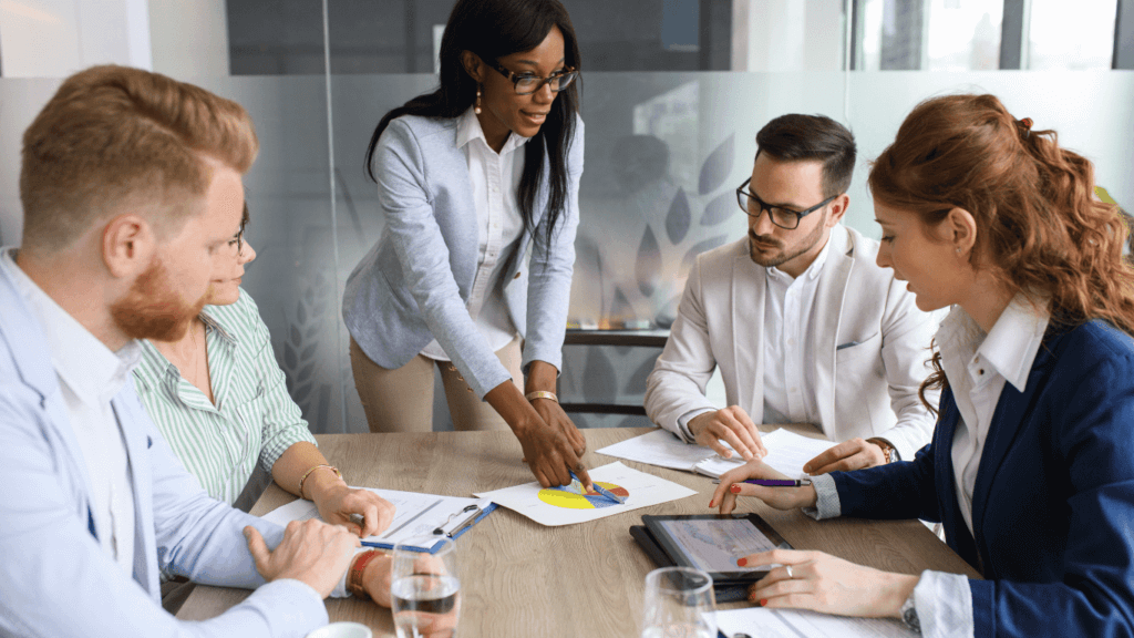 A group of sales reps discussing sales forecasting strategies