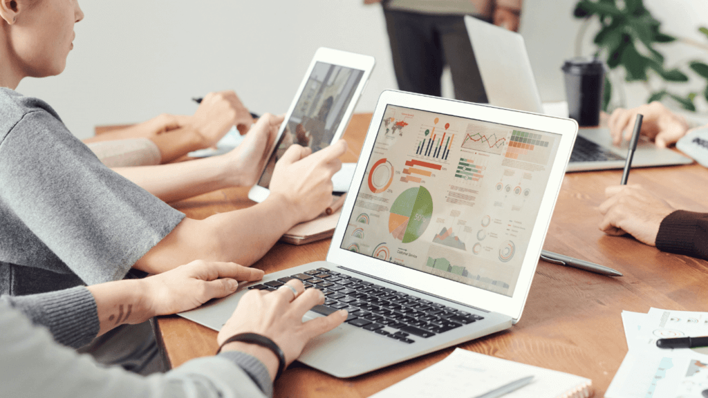 A person using a laptop to monitor competitors and industry trends