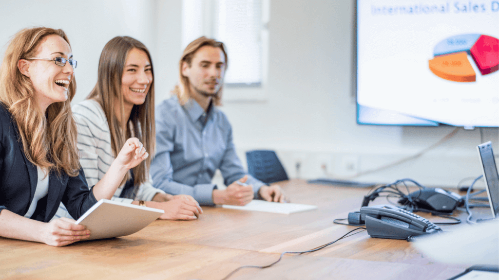 A sales team discussing the sales process and how to use it for forecasting
