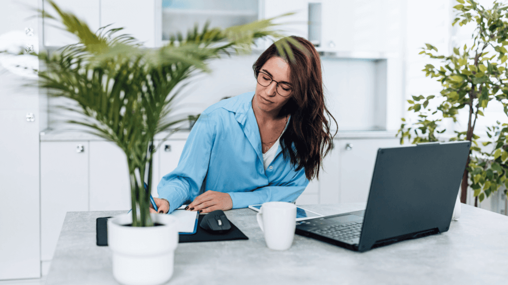 An appointment setter making calls in front of a laptop to lock in schedules for the sales team
