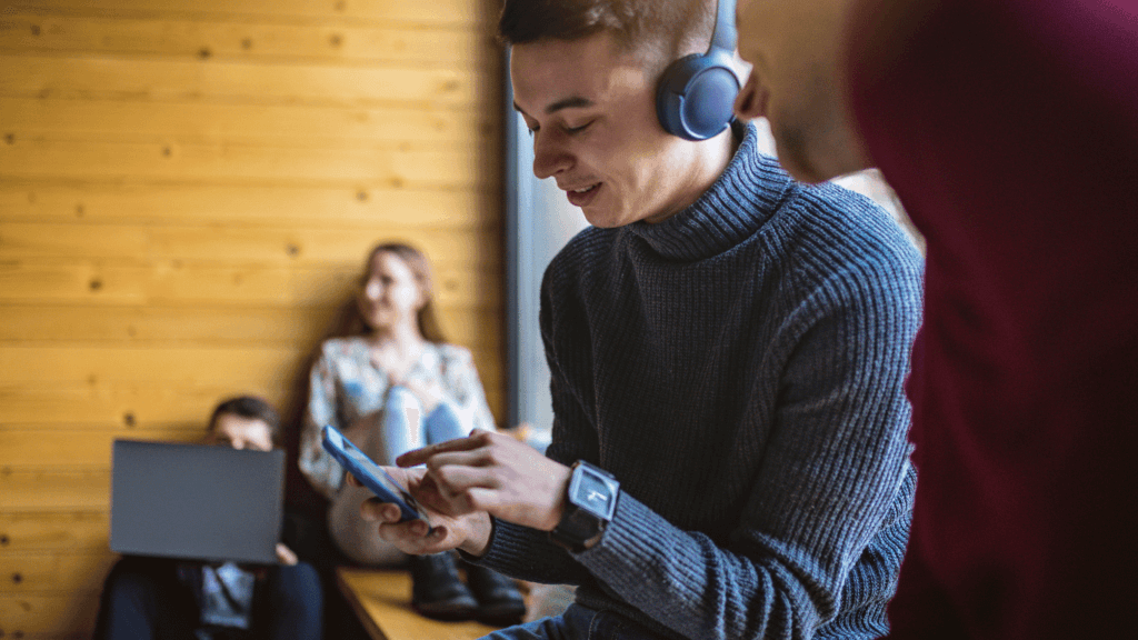 A sales rep listening to a sales podcast on their phone