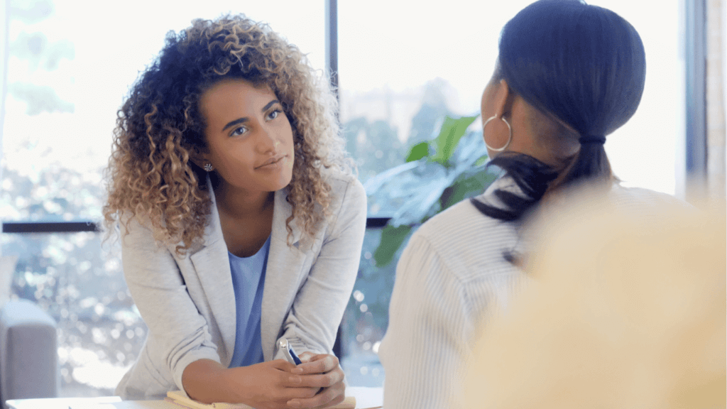 A customer support agent listening intently to a customer