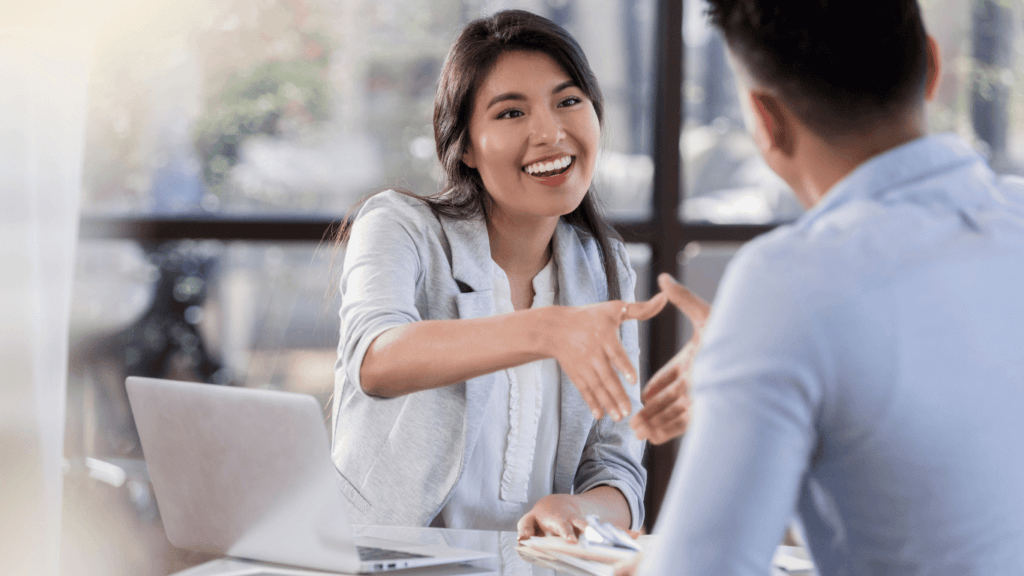 A sales professional talking to a customer and asking questions about the implications of their pain points