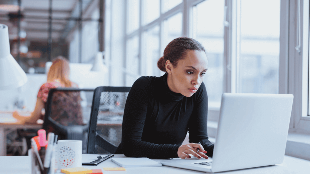 A person using a laptop to search for prospects on LinkedIn using Boolean search