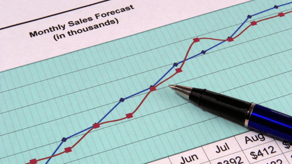 Sales leaders looking pleased at a sales graph illustrating sales figures and social selling.